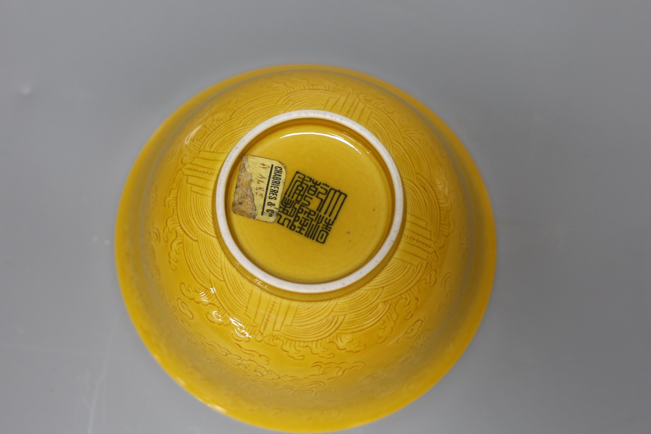 An 18th century Chinese export saucer dish (a.f), a Chinese blue and white dish and yellow ground ‘dragon’ bowl
